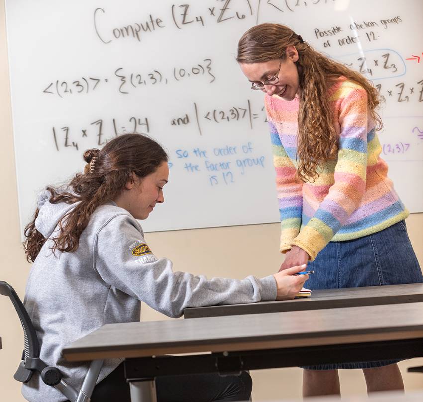 Math teacher working with a student